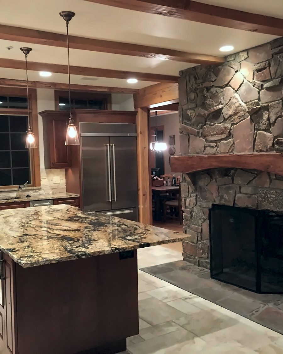 Kitchen with stone fireplace by Rhino Build