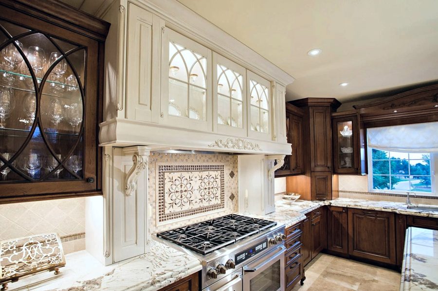 Custom cream hood with lit glass cabinets
