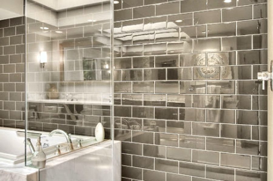 Glass shower with dark subway tile by Rhino Build