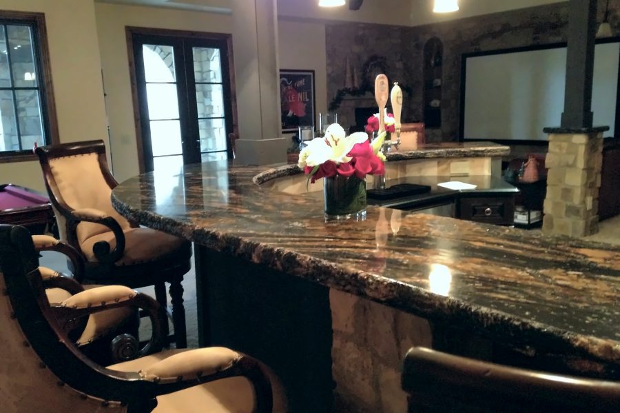 Curved granite wet bar in finished basement
